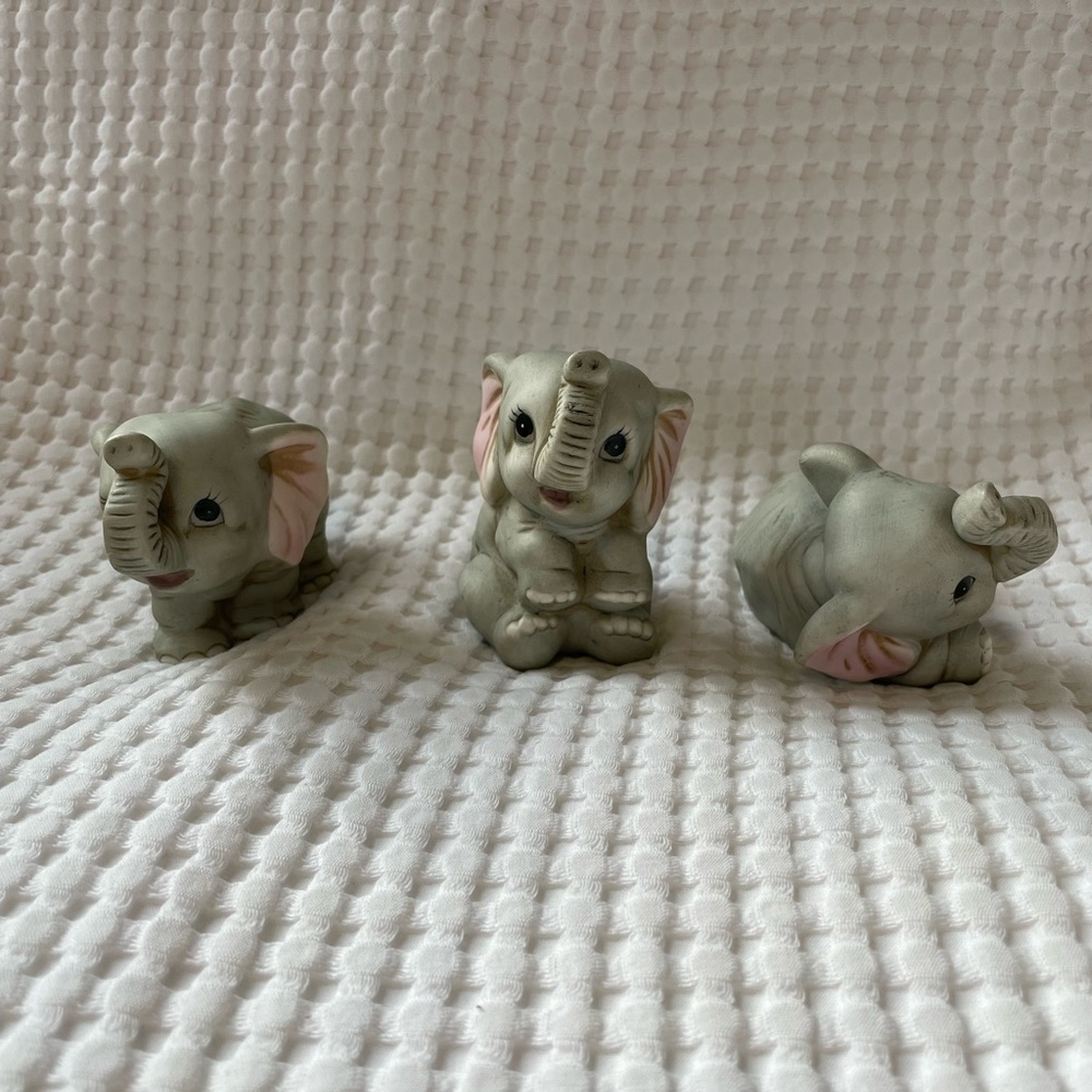 Three vintage ceramic baby elephants.